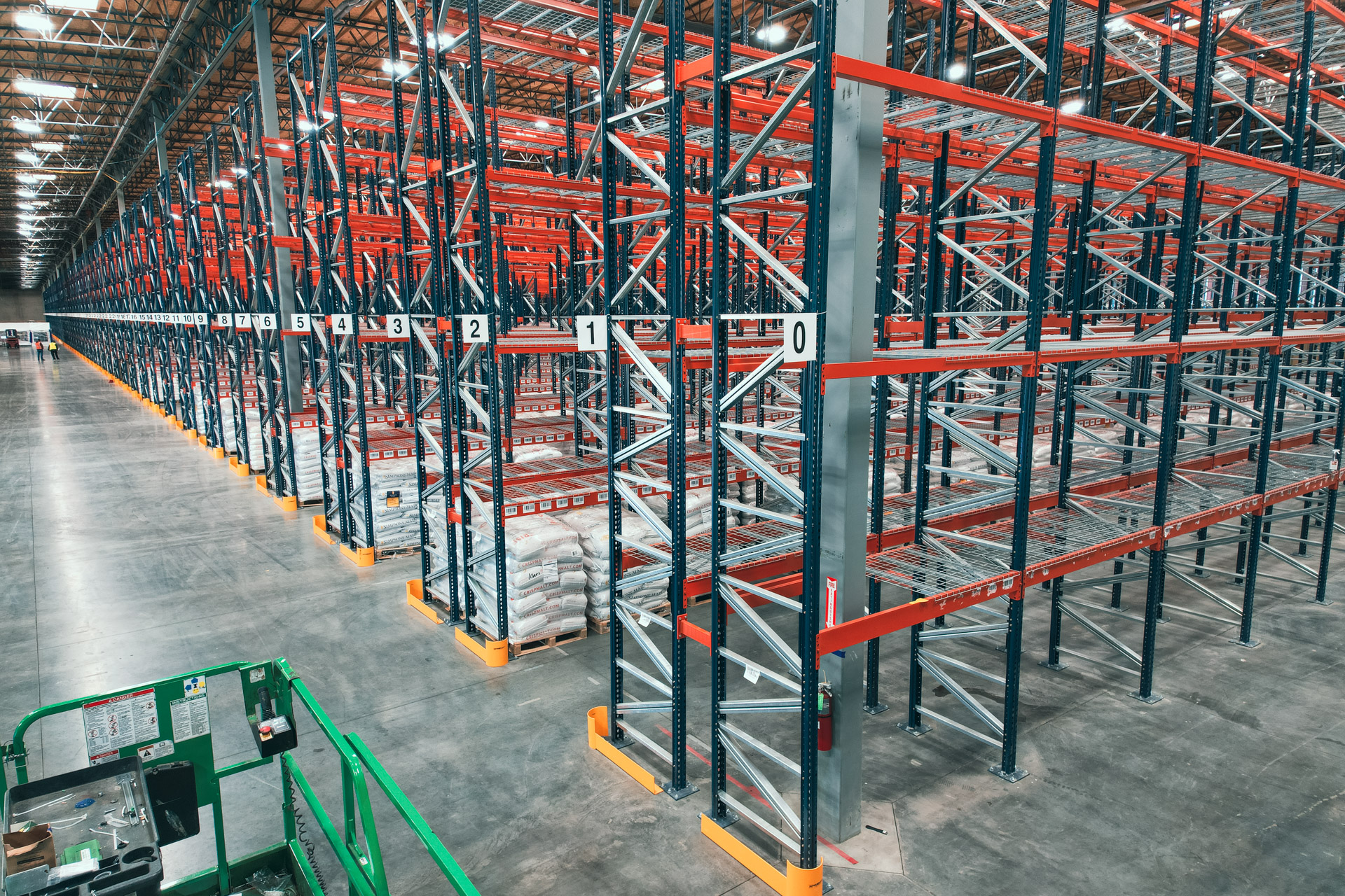Wide view of a warehouse floor with pallet rack rows